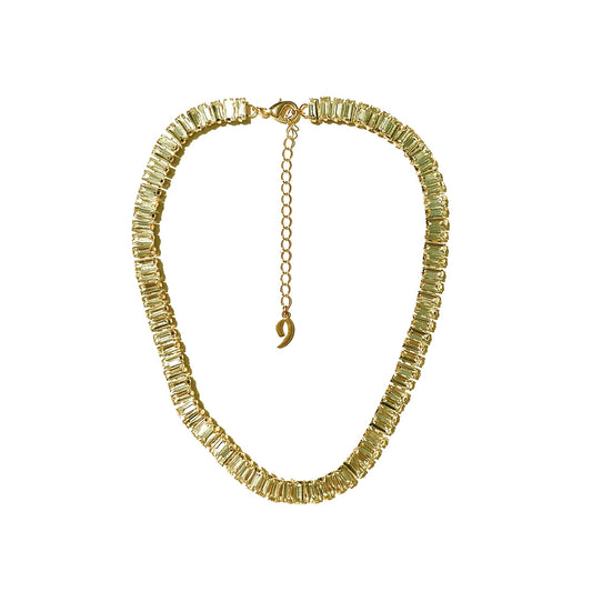 a necklace with a gold chain and a crescent