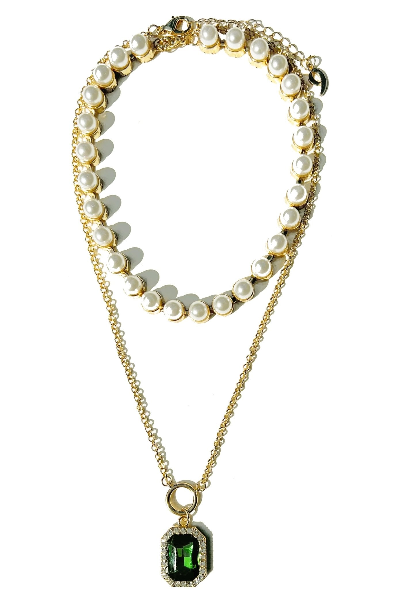 a necklace with pearls and a green stone