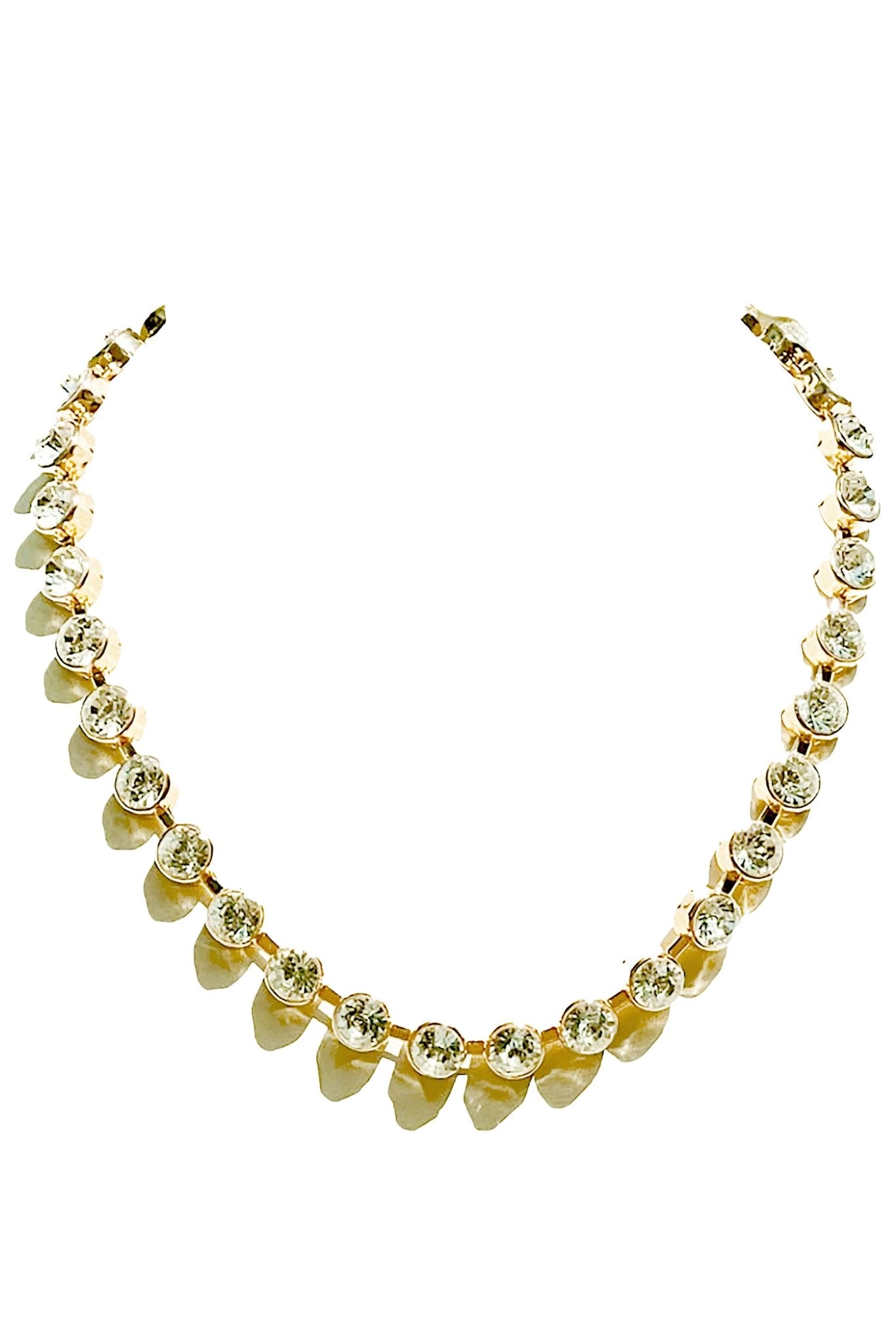 a gold necklace with hearts on a white background