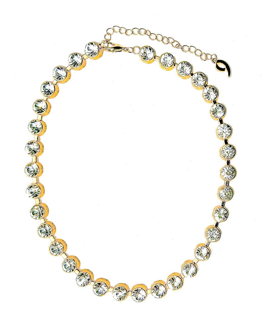 a gold and crystal necklace on a white background