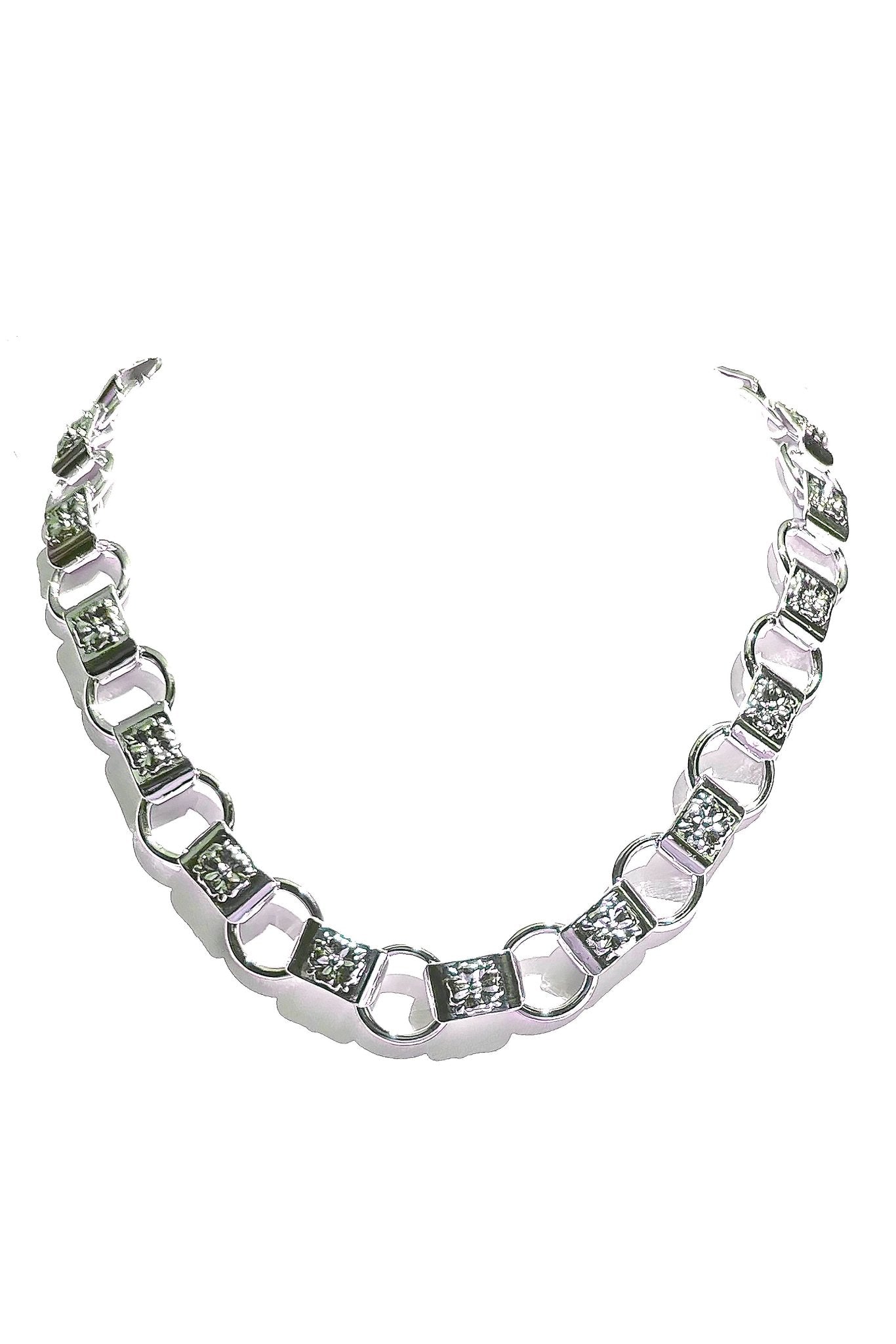 a silver necklace with diamonds on a white background