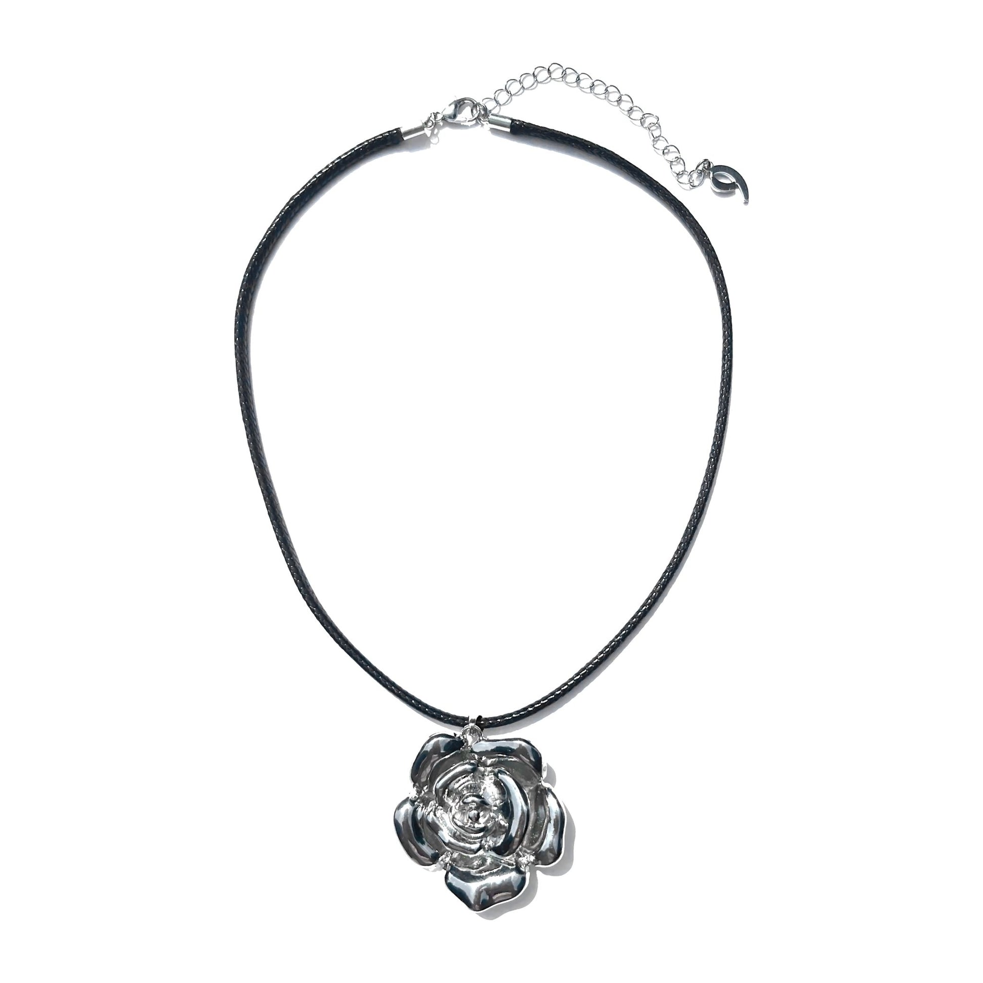 a necklace with a flower on a black cord